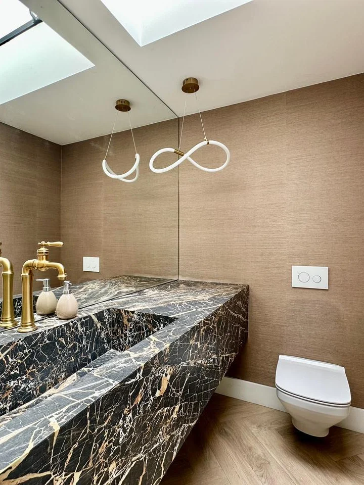 Baño con lavatorio de mármol y luz cenital